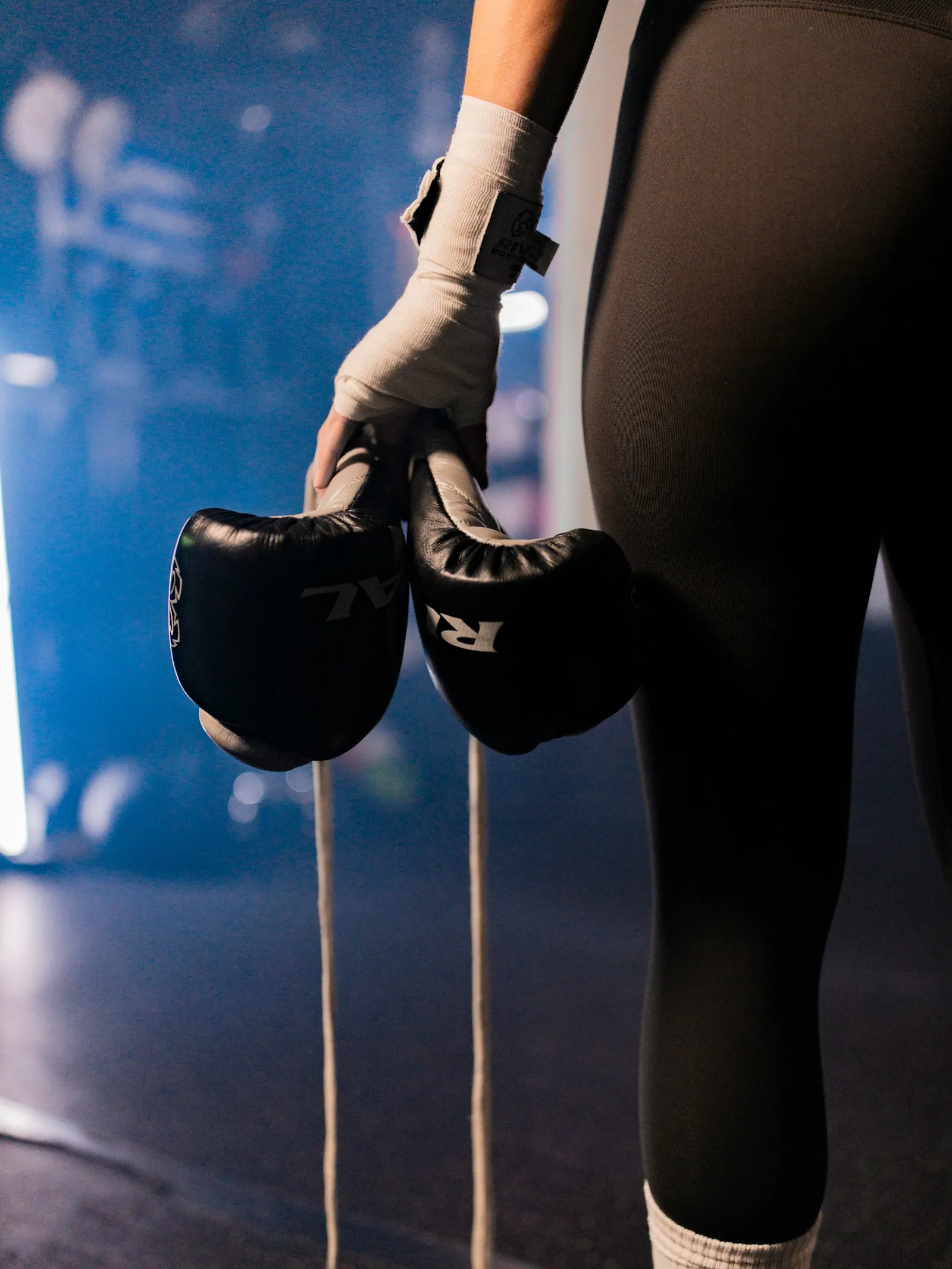 A boxer wrapping their hands beside the ring